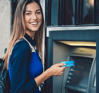 Woman using an ATM machine at FRMCU bank